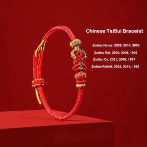 May include: A red cord bracelet featuring gold-colored woven accents and a central knot design. Text reads: Chinese TaiSui Bracelet, Zodiac Horse: 2026, 2014, 2002, Zodiac Rat: 2020, 2008, 1996, Zodiac Ox: 2021, 2009, 1997, Zodiac Rabbit: 2023, 2011, 1999.