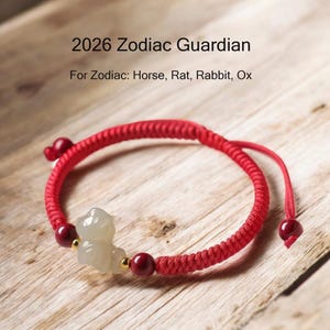 May include: Red braided bracelet with a light-colored animal charm and red beads. The text "2026 Zodiac Guardian" and "For Zodiac: Horse, Rat, Rabbit, Ox" are visible.