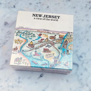 May include: A colorful illustration of a map of New Jersey with the text "NEW JERSEY a view of the world". The map shows major cities and landmarks, including Trenton, Atlantic City, and the Jersey Turnpike.