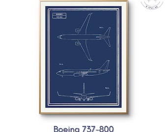 May include: A framed blueprint-style print of a Boeing 737-800 aircraft, featuring three views of the plane in white lines against a dark blue background. The print includes the text "Boeing 737-800" and "Original artwork | Created by humans."