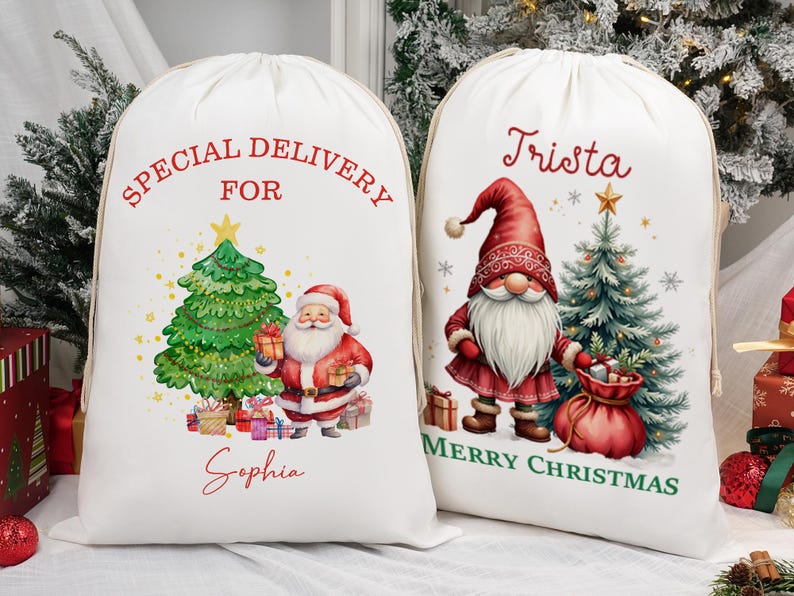 May include: Two white Christmas gift sacks with drawstring closures. One sack features a Santa Claus illustration with a Christmas tree and the text "Special Delivery For Sophia." The other sack has a gnome illustration, a Christmas tree, and the text "Trista Merry Christmas."