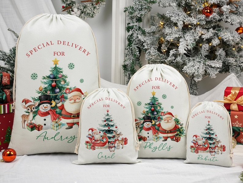 May include: Four cream-coloured Christmas gift sacks with drawstring closures. Each sack features a festive design with a Christmas tree, Santa Claus, a snowman, and the text "SPECIAL DELIVERY FOR" with a name below.
