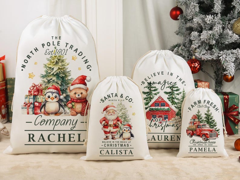 May include: Four white Christmas gift bags with drawstring closures. Each bag features a unique festive design, including Santa Claus, a penguin, a red truck, and a Christmas tree. The bags are personalised with names.