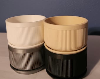 Succulent planter that is modern and holds plants for gardening with dish
