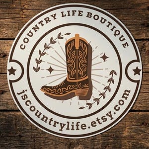 May include: A round sticker with a brown and tan cowboy boot design. The text "COUNTRY LIFE BOUTIQUE" is in a circular pattern around the boot. The Etsy shop name "jscountrylife.etsy.com" is also included.