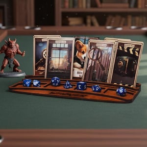 May include: A wooden gaming table with a green felt surface, featuring a miniature demon figure, playing cards, and blue dice. The cards are displayed in a wooden holder. A fireplace and bookshelf are in the background.