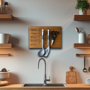 May include: A wooden grilling station with hooks for hanging utensils. The station has a brown wood finish and is labeled "Jimmy's Grilling Station". It features a list of different types of meat and their corresponding cooking times. Two gray and black kitchen utensils are hanging from the hooks.