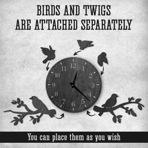 May include: A black and white wall clock with a circular face and separate bird and twig accents. The clock face has numbers and hands. Text on the image reads "BIRDS AND TWIGS ARE ATTACHED SEPARATELY" and "You can place them as you wish."