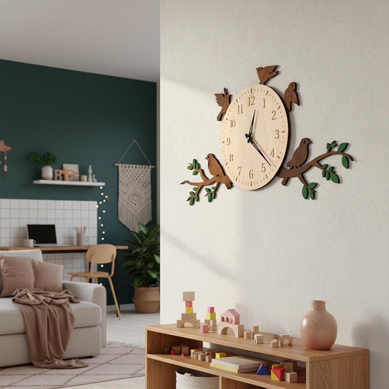May include: A wooden wall clock featuring a light-colored clock face with black numerals and hands. The clock is surrounded by a brown branch with green leaves and brown bird cutouts. The clock is mounted on a white wall.