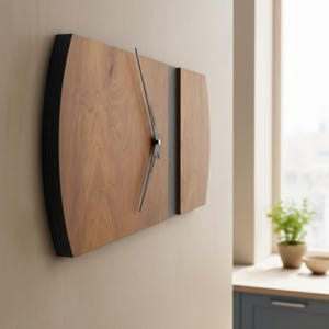May include: A modern wall clock with a rectangular wooden face. The clock features a light brown wood grain with black edges and a dark gray vertical stripe. The clock hands are black.