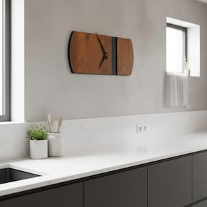 May include: A rectangular wooden wall clock with a dark brown finish and black accents. The clock has a minimalist design with black clock hands. The clock is mounted on a light gray wall in a kitchen setting.