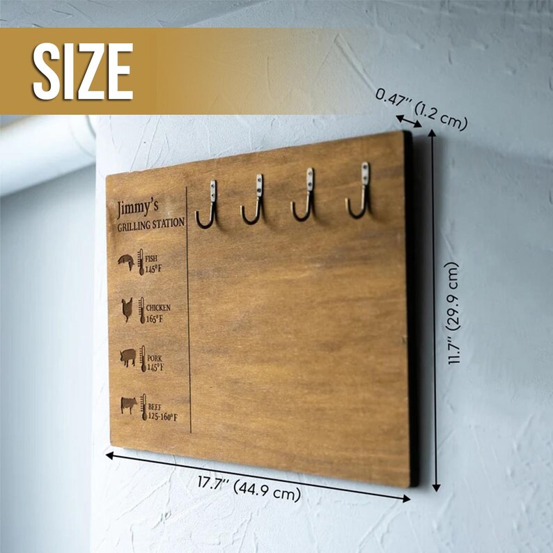 May include: A wooden grilling station sign with five hooks, measuring 17.7 inches by 11.7 inches. The sign features the text "Jimmy's Grilling Station" and a chart with recommended cooking temperatures for fish, chicken, pork, and beef.