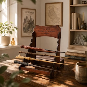 May include: A wooden wand display stand with four wands. The stand has the text "THE WAND CHOOSES THE WIZARD." The wands are various colors and designs. The display is on a wooden table.