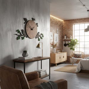 May include: A wooden wall clock with a light brown face and black hands. The clock is decorated with birds and branches in shades of green and gray. The clock is mounted on a textured gray wall.