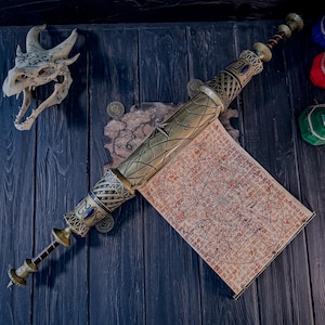 May include: A detailed, antique-style scroll case with a map, featuring brass and gold accents, and blue gemstones. The scroll is displayed on a dark wooden surface, with a dragon skull and decorative elements in the background. The scroll case is approximately 18 inches long.