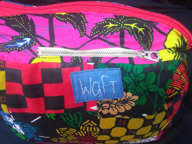May include: A colorful patchwork fabric zippered pouch with a blue label that says "WAFT".