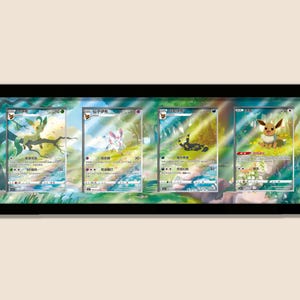 May include: A framed display of four Pokémon trading cards. Each card depicts a different Pokémon character set against a vibrant, illustrated backdrop. The cards are presented within a black frame, offering an attractive display for collectors.