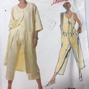 May include: A vintage Vogue Pattern Individualist sewing pattern showing a two-piece outfit. The pattern includes a long-sleeved jacket and wide-leg trousers, and a sleeveless jumpsuit. The outfits are a pale yellow colour.