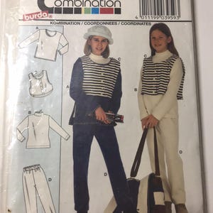 May include: A vintage Burda Super Combination sewing pattern packet. The packet features illustrations of a matching outfit, including a striped vest, long-sleeved shirt, and trousers. The packet also includes the number 3959.