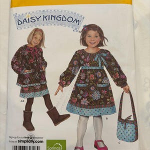 May include: Simplicity sewing pattern 2348, size BB 5, 6, 7, 8, featuring Daisy Kingdom designs. The envelope displays illustrations of long-sleeved dresses with floral patterns, a blue polka-dot hem, and a matching handbag, with a barcode at the bottom.