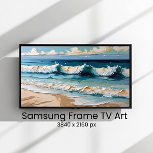 Könnte beinhalten: Ein gerahmtes Gemälde einer Strandszene mit Meereswellen in Blau- und Weißtönen und einem Sandstrand. Das Kunstwerk wird an einer Wand ausgestellt. Der Text "Samsung Frame TV Art" befindet sich unten.