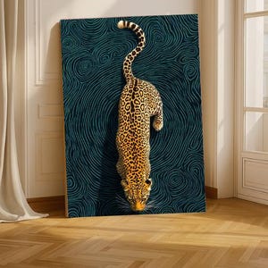 May include: A large canvas art print depicting a leopard with a spotted coat, descending against a teal background with swirling lines. The artwork is displayed on a wooden frame, leaning against a wall.