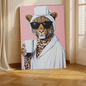 May include: A canvas print depicting a leopard wearing sunglasses, a white robe, and a towel on its head, holding a white mug. The background is a solid pink colour.