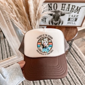 Dolly Parton “Tease it to Jesus and Spray it like hell” Trucker hat