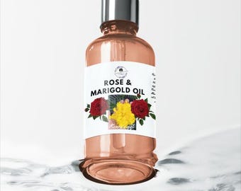 May include: A clear glass bottle of Rose & Marigold Oil with a black dropper top. The label features the text "Rose & Marigold Oil" with images of red roses and yellow marigolds. The bottle is partially submerged in water.