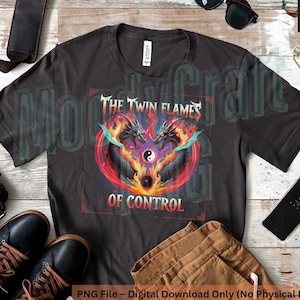 May include: A black t-shirt featuring a graphic design of two flames with a yin yang symbol at the centre. The text "The Twin Flames of Control" is printed on the shirt.
