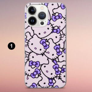 May include: A clear smartphone case featuring a repeating pattern of light purple Hello Kitty character faces with dark outlines and purple bows. The case is shown on a phone with a triple-lens camera system and the number 1 in a black circle.