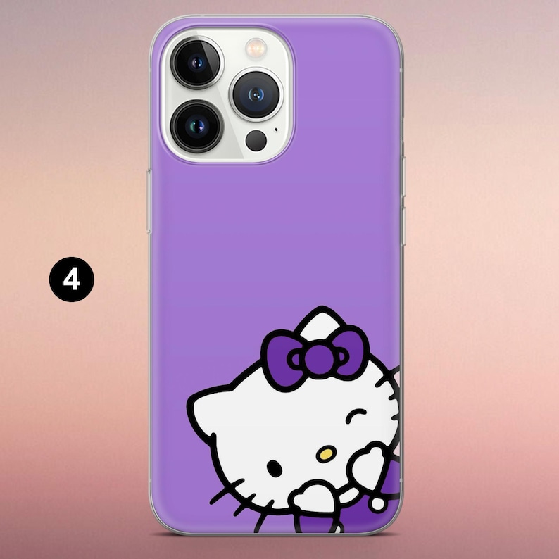 May include: A purple smartphone case featuring a graphic of a white Hello Kitty character with a dark purple bow. The character is positioned at the bottom right corner of the case. The camera lens array is visible at the top left of the device.