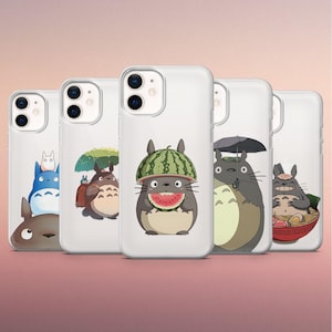 May include: Clear phone cases featuring various illustrations of the animated character Totoro. The designs include Totoro with a watermelon hat, holding an umbrella, and eating ramen. The cases are designed to fit a smartphone.