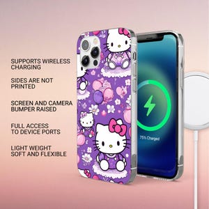 May include: A purple phone case featuring a repeating pattern of Hello Kitty characters, pink balloons, and white flowers. The case is shown on a smartphone with a screen displaying a green charging icon and the text 75% Charged, next to a wireless charger.