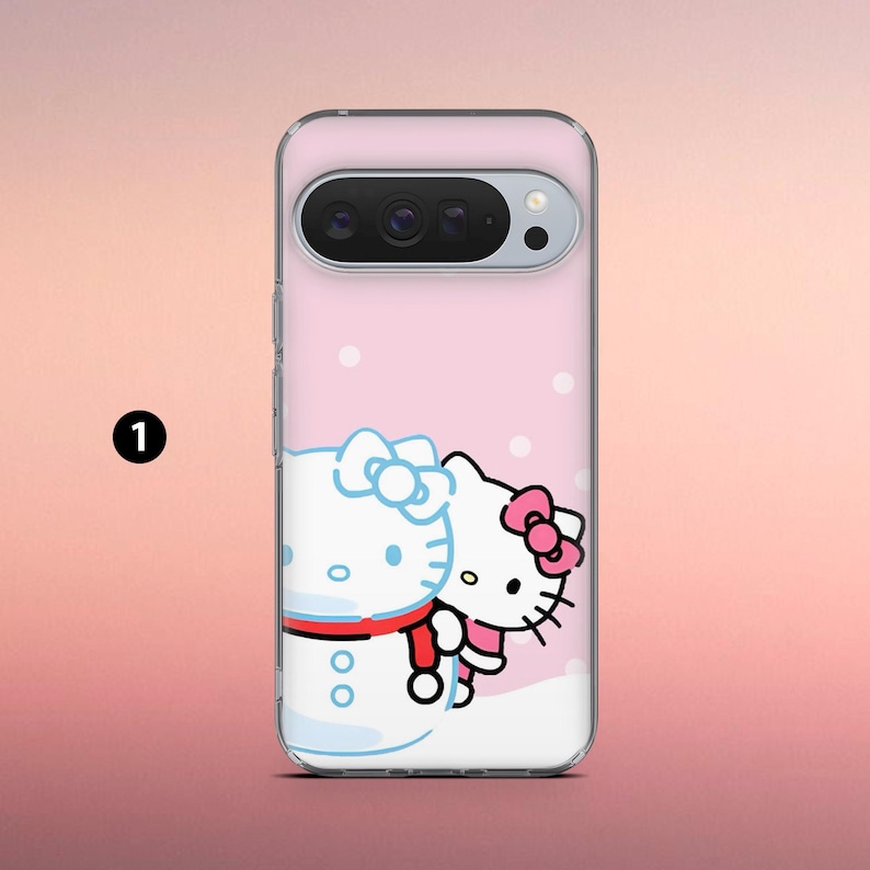May include: A clear phone case featuring a pink background with white polka dots. The case has a cartoon illustration of Hello Kitty and a snowman. Hello Kitty is wearing a pink bow and the snowman has a blue bow and red scarf.
