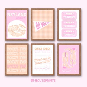 May include: Six framed prints with a pink and orange color scheme. The prints feature text and illustrations related to Tennessee, including "Neyland Stadium," "Go Vols," "Rocky Top," and "Meet me in Knoxville!" The prints are in wooden frames.