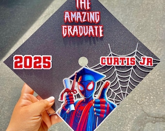 May include: Black graduation cap with the words "THE AMAZING GRADUATE" in red and white. Features a Spider-Man graphic and the name "CURTIS JR" with the year "2025".