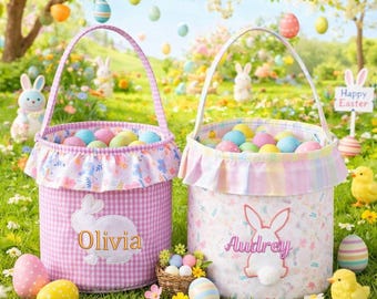 May include: Two Easter baskets filled with colourful eggs on grass. One is pink gingham with "Olivia" and a bunny. The other is floral with "Audrey" and a bunny. The scene includes Easter eggs, chicks, and a "Happy Easter" sign.