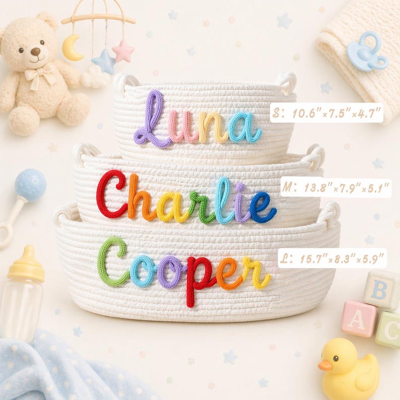 May include: Three white woven rope baskets stacked vertically, each featuring a colourful name in cursive script. The top basket reads Luna, the middle Charlie, and the bottom Cooper. Dimensions are labelled as S: 26.9x19.1x11.9 cm, M: 35.1x20.1x13 cm, and L: 39.9x21.1x15 cm.