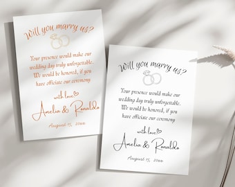 Puede incluir: Dos tarjetas blancas con el texto "Will you marry us?" en escritura elegante, con un gráfico de anillos. Las tarjetas incluyen un mensaje sincero, los nombres "Amelia & Ronaldo" y la fecha 15 de agosto de 20xx. Una tarjeta tiene texto naranja, la otra negro.