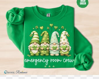 May include: Green sweatshirt with four gnome characters holding shamrocks. The gnomes have different patterned hats and outfits. The text "emergency room crew" is written in white script. The sweatshirt has long sleeves and the words "Irish Green" are in a circle.