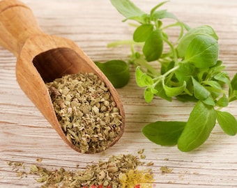 May include: A wooden scoop holds dried oregano, with fresh oregano sprigs beside it. The dried herb is a mix of green and brown, contrasting with the bright green of the fresh leaves. The image includes the logo "gullüoglu 1871".