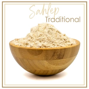 May include: A wooden bowl filled with a light beige powder, possibly a spice or flour. The bowl has a natural wood grain and is set against a white background. The text "Sahlep Traditional" is written in a decorative font above the bowl.