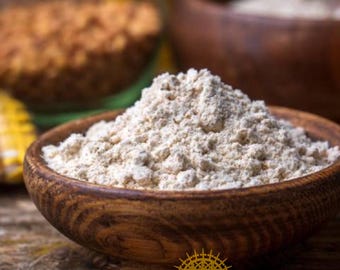 May include: A wooden bowl brimming with light-coloured flour, possibly for baking or cooking. The bowl sits on a wooden surface, with other bowls of ingredients in the background. The image suggests a focus on natural ingredients and home cooking.