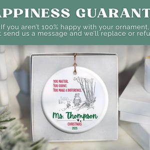 May include: A white ceramic Christmas ornament featuring a Winnie the Pooh illustration with the text "You Matter, You Count, You Make a Difference." The ornament is personalized with "Ms. Thompson" and "Christmas 2025."