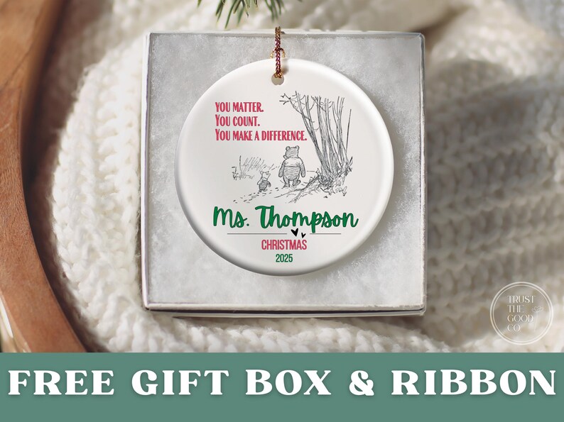 May include: A white ceramic Christmas ornament with a Winnie the Pooh illustration and the text "YOU MATTER. YOU COUNT. YOU MAKE A DIFFERENCE." The ornament is personalized with "Ms. Thompson" and "CHRISTMAS 2025."