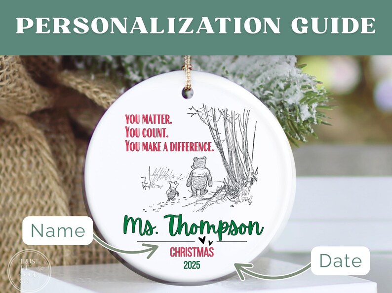 May include: A white ceramic Christmas ornament with a gold string for hanging. The ornament features a Winnie the Pooh illustration and the text "YOU MATTER. YOU COUNT. YOU MAKE A DIFFERENCE." It is personalized with a name and the year 2025.