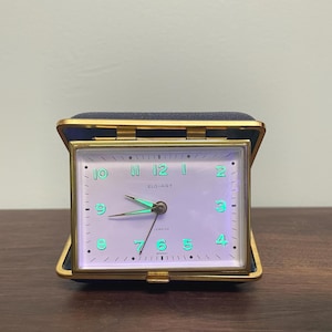 Réveil de voyage mécanique Elg-Art vintage, fabriqué en Allemagne de l'Ouest, à réparer. Radium phosphorescent sous UV.