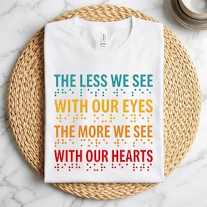 May include: A set of three ceramic mugs with a speckled, matte finish. The mugs are in shades of cream, light gray, and dark gray. Each mug has a simple, minimalist design and a rounded handle.