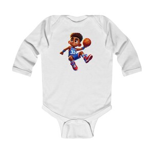 May include: White long-sleeve baby bodysuit featuring a cartoon illustration of a young basketball player. The player is wearing a blue jersey with the number 32, red shoes, and is holding a basketball. The design is colorful and playful.